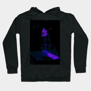 Special processing. Person walking at night, on dark street, with stone walls. Blue. Hoodie